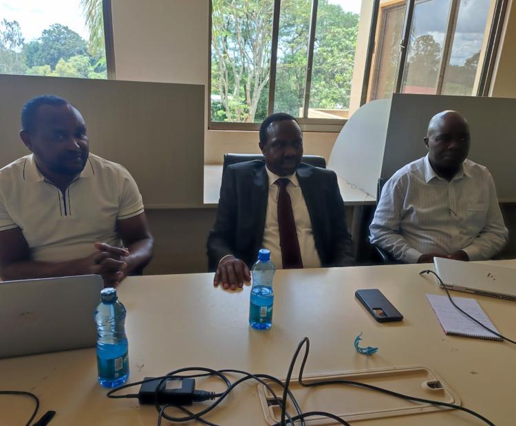 Mr. Phillip Tarus (centre) follows the proceedings.