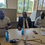 Mr. Phillip Tarus (centre) follows the proceedings.